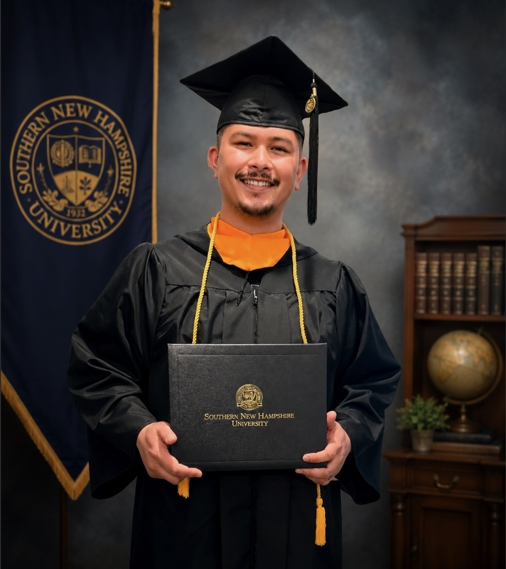 Mako Wusstig wearing his Southern New Hampshire University graduation cap and gown
